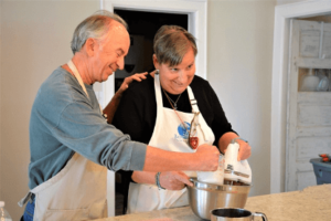 Couple in cooking class mixing ingredients