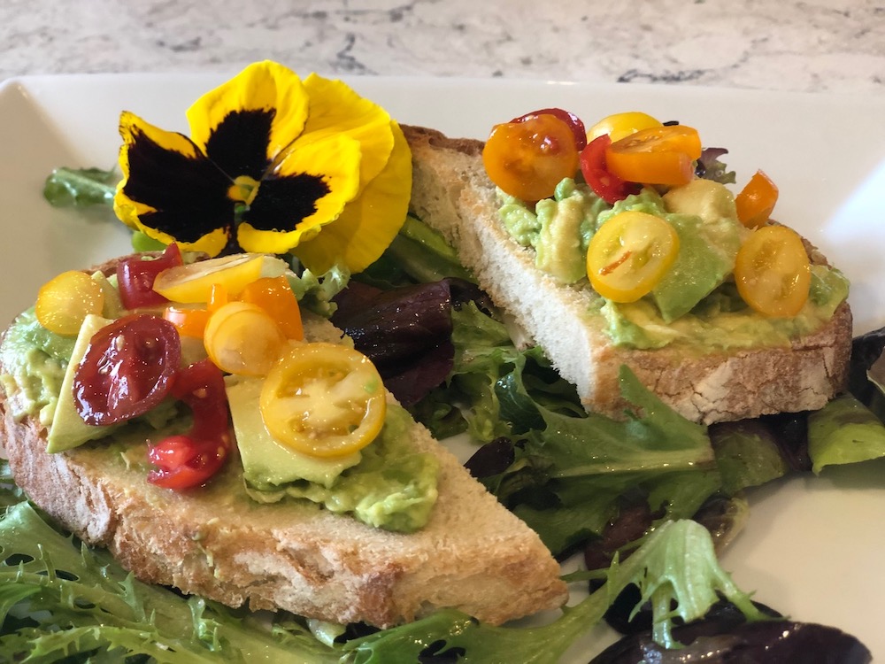 Sandwich with veggies and a pansy