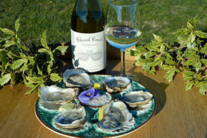 Wine bottle with a plate of oysters