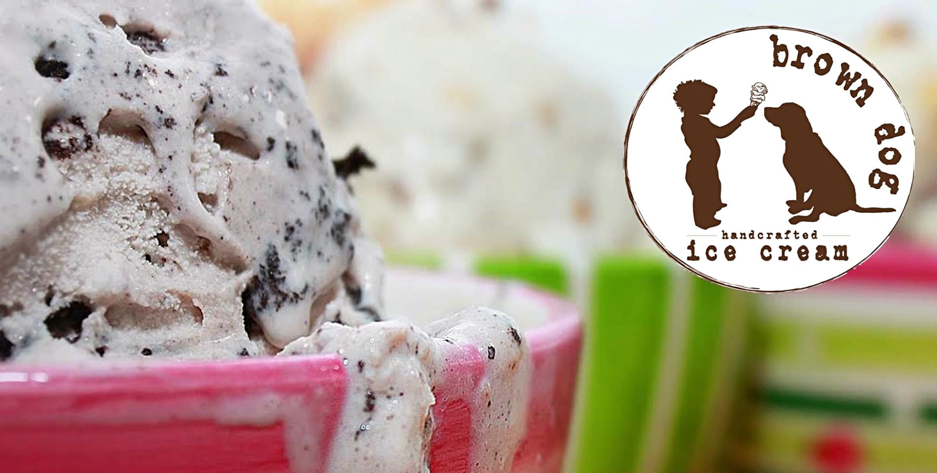 A hearty scoop of cookies & cream ice cream in a pink bowl with the text: brown dog handcrafted ice cream. 